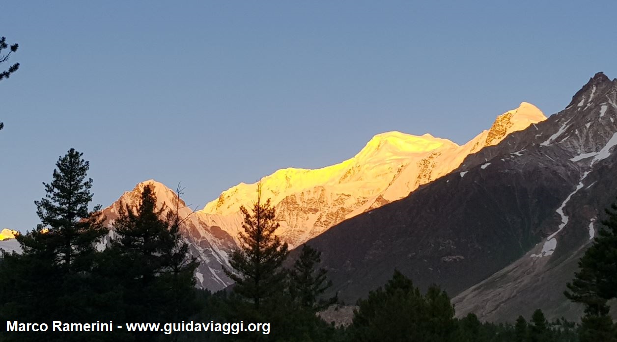 Travel in the mountains of Central Asia. The first light of dawn on Nanga Parbat, Pakistan. Author and Copyright Marco Ramerini