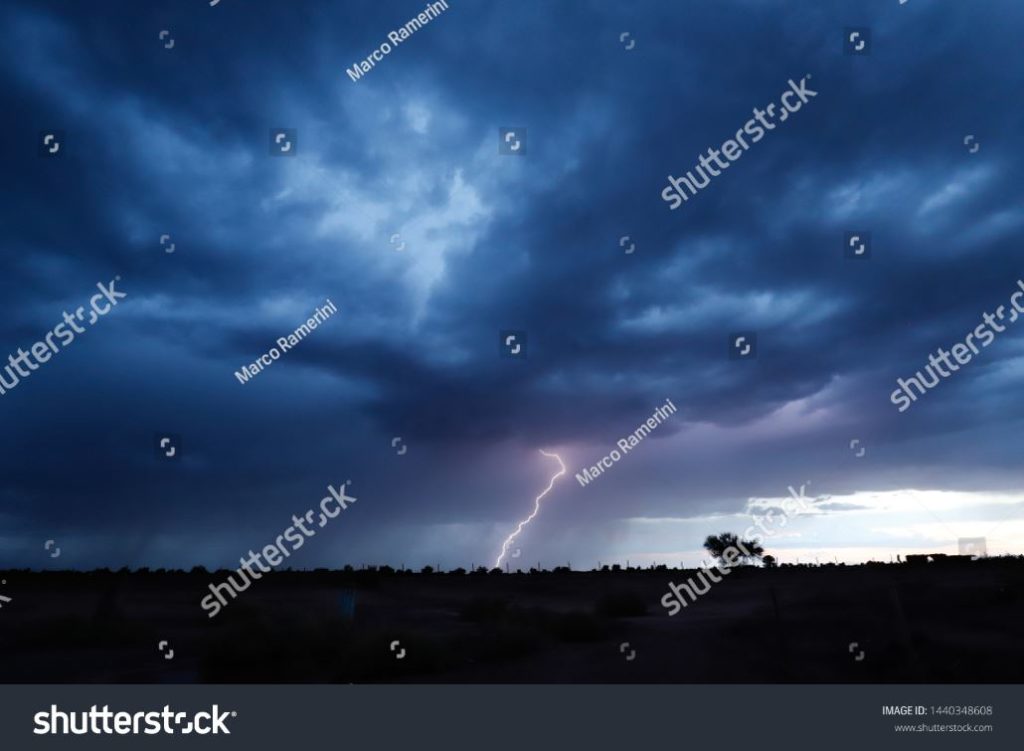 Lightning during a thunderstorm in the light of sunset in the arid landscape of the Atacama desert, Chile. Author and Copyright Marco Ramerini